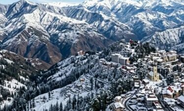 Wide angle landscape photography of beautiful Shimla in winter with snow-capped Himalayan mountains