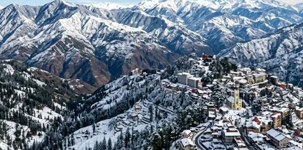 Wide angle landscape photography of beautiful Shimla in winter with snow-capped Himalayan mountains