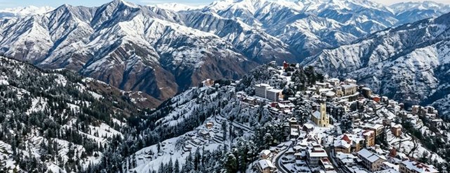 Wide angle landscape photography of beautiful Shimla in winter with snow-capped Himalayan mountains