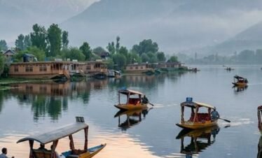 Serene dawn over Dal Lake in Srinagar Kashmir with traditional Shikara boats