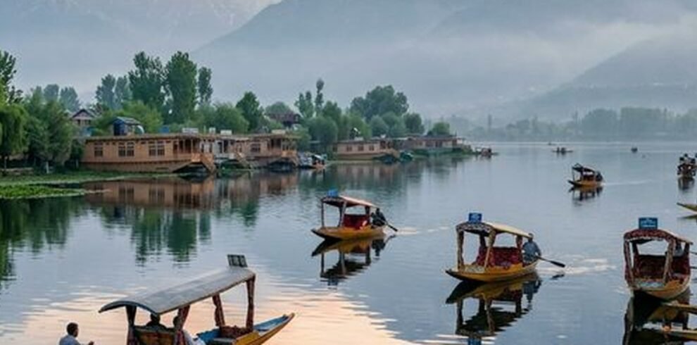 Serene dawn over Dal Lake in Srinagar Kashmir with traditional Shikara boats
